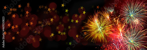 Colorful fireworks on black background with stars and dark red bokeh for christmas, anniversary, new year, event, celebration and festival