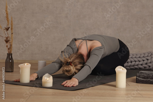 Woman doing yoga pain relief stretching at home. Self Care, Healing concept photo