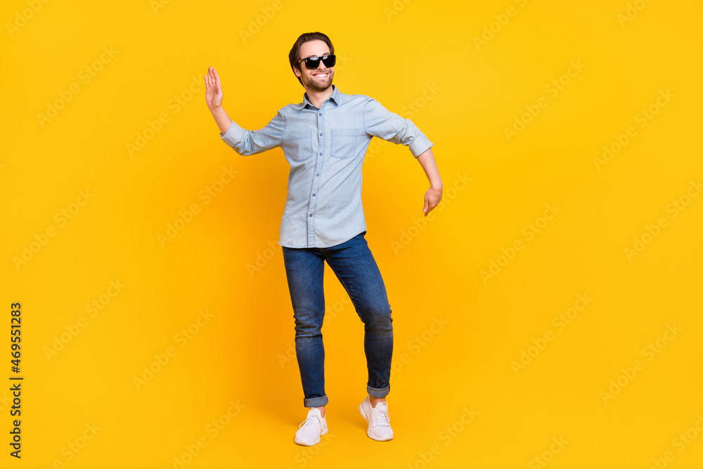Full body photo of young handsome man happy positive smile funny dance hipster clubber isolated over yellow color background