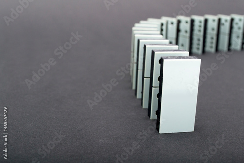 Dominoes falling in a row   gray background
