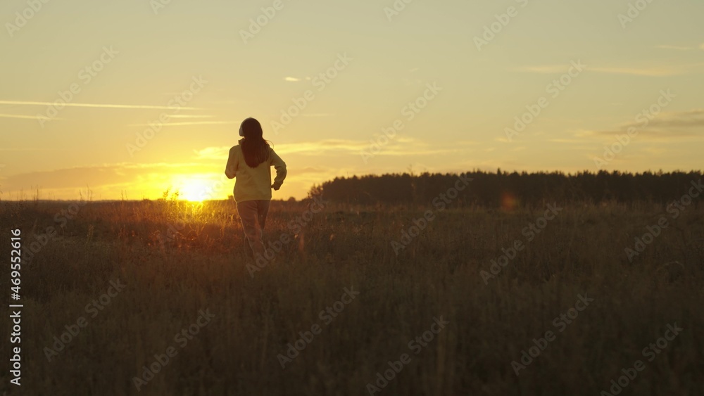 girl runs at sunset in a tracksuit, jogging actifa cardio workouts, fitness jogging in the sun, athletic young woman preparing for a competition, healthy lifestyle and a good figure of a man's dream