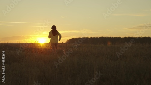 girl runs at sunset in a tracksuit  jogging actifa cardio workouts  fitness jogging in the sun  athletic young woman preparing for a competition  healthy lifestyle and a good figure of a man s dream