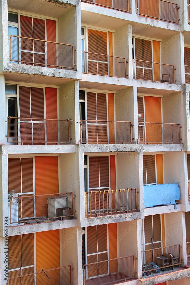 abandoned block from communist times, orange balconies, orange window blinds, closed window blinds, many balconies, Rijeka