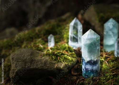Different crystals on moss in forest, space for text