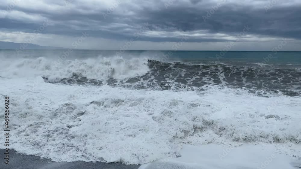 the stormy sea pushed by the wind raises high waves on the beach of Sicily the stormy sea pushed by the wind raises high waves on the beach of Sicily