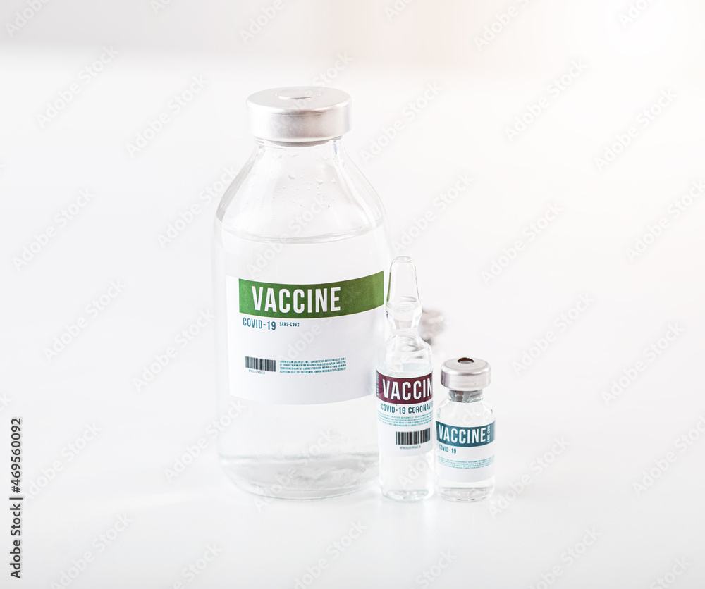 Various bottles with vaccine from covid standing on white table. Medical liquid for virus protection. Vaccination concept. Various bottles with vaccine from covid standing on white table. Medical liquid for virus protection. Vaccination concept.
