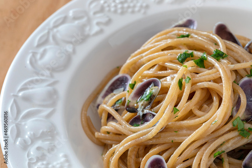 Close up of a plate with spaghetti and tellinas clams. photo