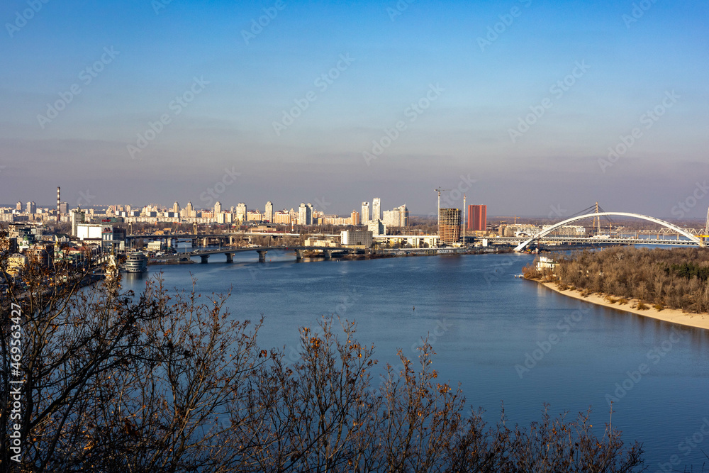 View of the city of Kiev and the Dnieper river with bridges, houses and parks.