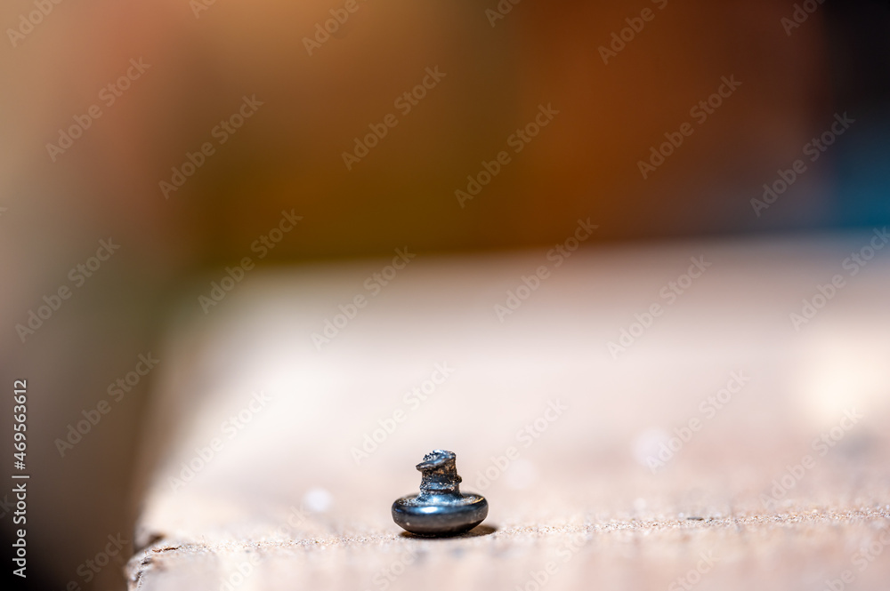 bolt head turned over to show sheared threading after stress failure