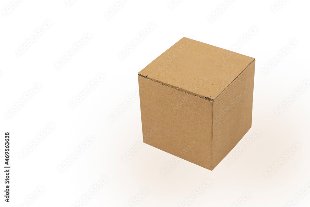 A small cardboard box made of corrugated cardboard on a white background with a light shadow A small cardboard box made of corrugated cardboard on a white background with a light shadow