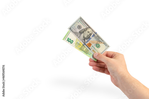 Money in hand on a white background, isolated money in a man's hand. One hundred dollar banknote and one hundred euro banknote.