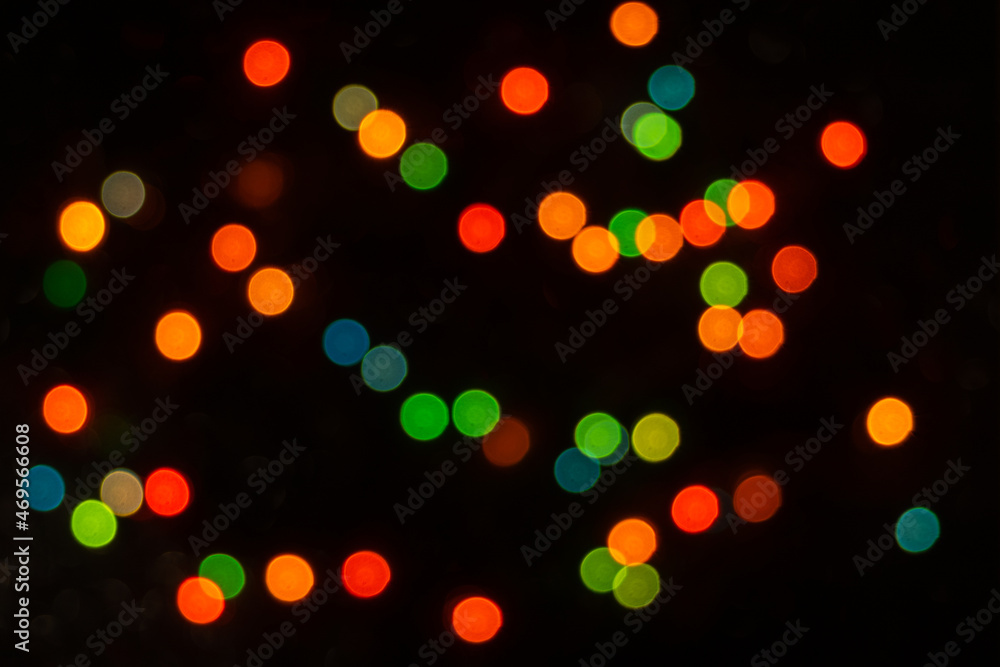 Perfect bokeh for a festive New Year and Christmas background. Defocused abstract yellow, green light circles.