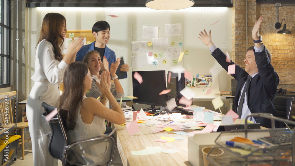 A successful group of multi ethnic business team employee have a meeting, having fun, throwing