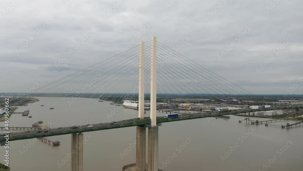 cars and trucks driving on cable-stayed bridge above water. One direction of traffic. Queen Elizabeth II Bridge, Dartford, UK cars and trucks driving on cable-stayed bridge above water. One direction of traffic. Queen Elizabeth II Bridge, Dartford, UK