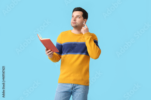 Young man with book and ear...