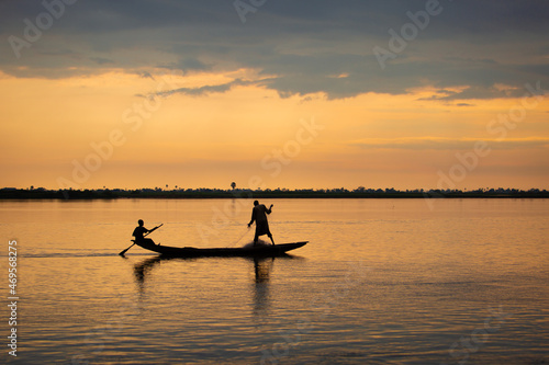 A man rowing on river niger in Africa trying to catch fish © Taiwo