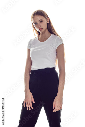Young woman in white t-shirt isolated on white background. Mock-up. © kanashkin