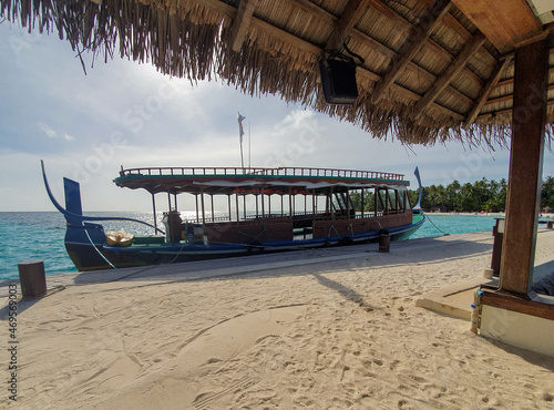 Maldives traditional boat Dhonimoored to the pier. Luxury tropical paradise concept photo