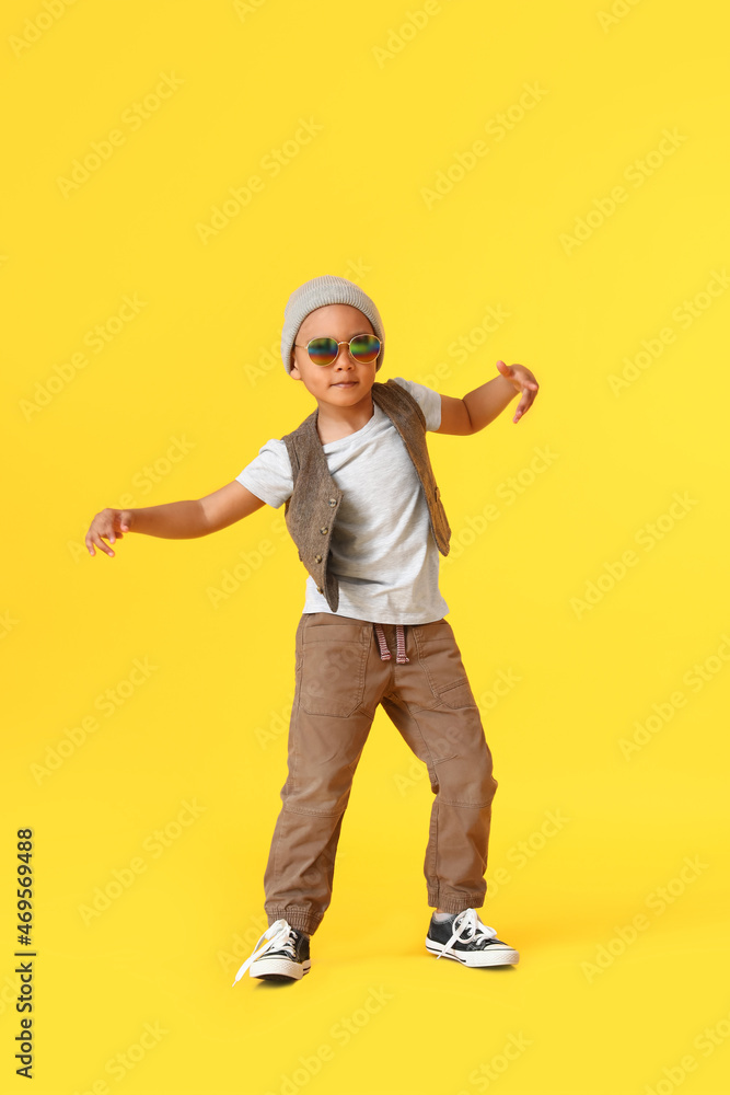 Cute dancing African-American boy on color background Cute dancing African-American boy on color background