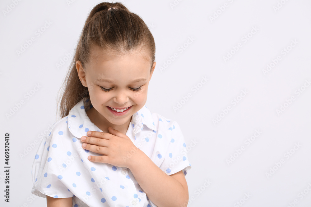 Portrait of flattered little girl on light background Portrait of flattered little girl on light background