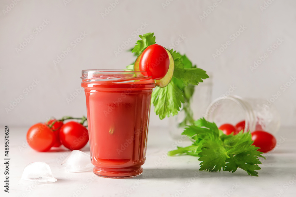 Glass of bloody mary with celery and tomatoes on table Glass of bloody mary with celery and tomatoes on table