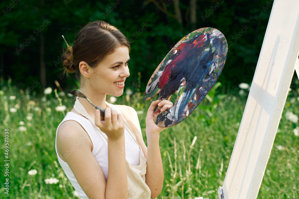 cheerful woman paints a picture palette nature landscape cheerful woman paints a picture palette nature landscape