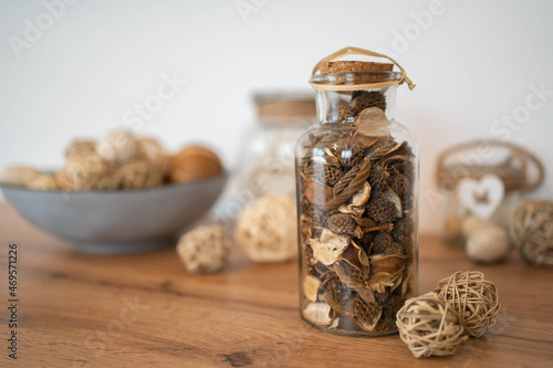 The potpourri in glass bottle on a wood table, provides a relaxing scent and celebration. photo