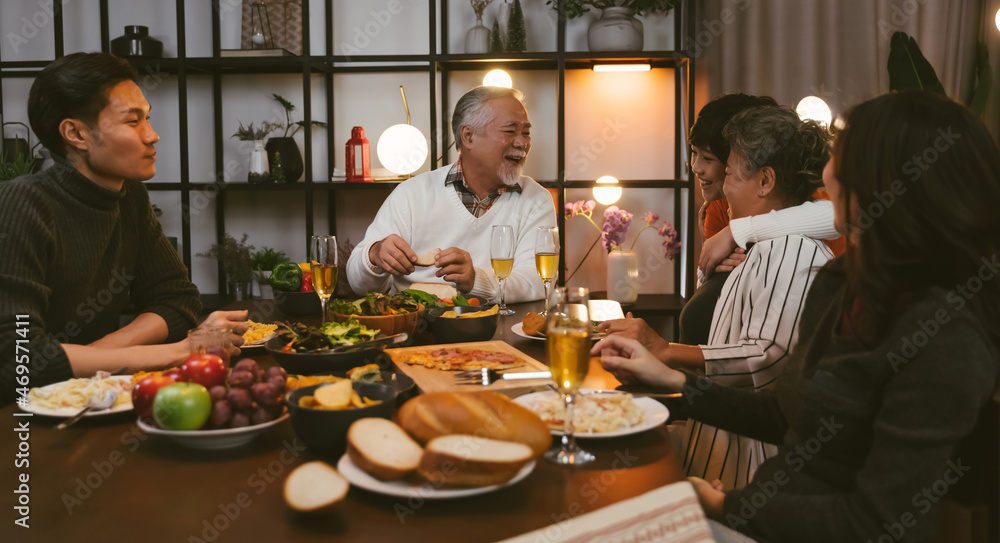 Asian family having dinner at dining table at home Asian family having dinner at dining table at home