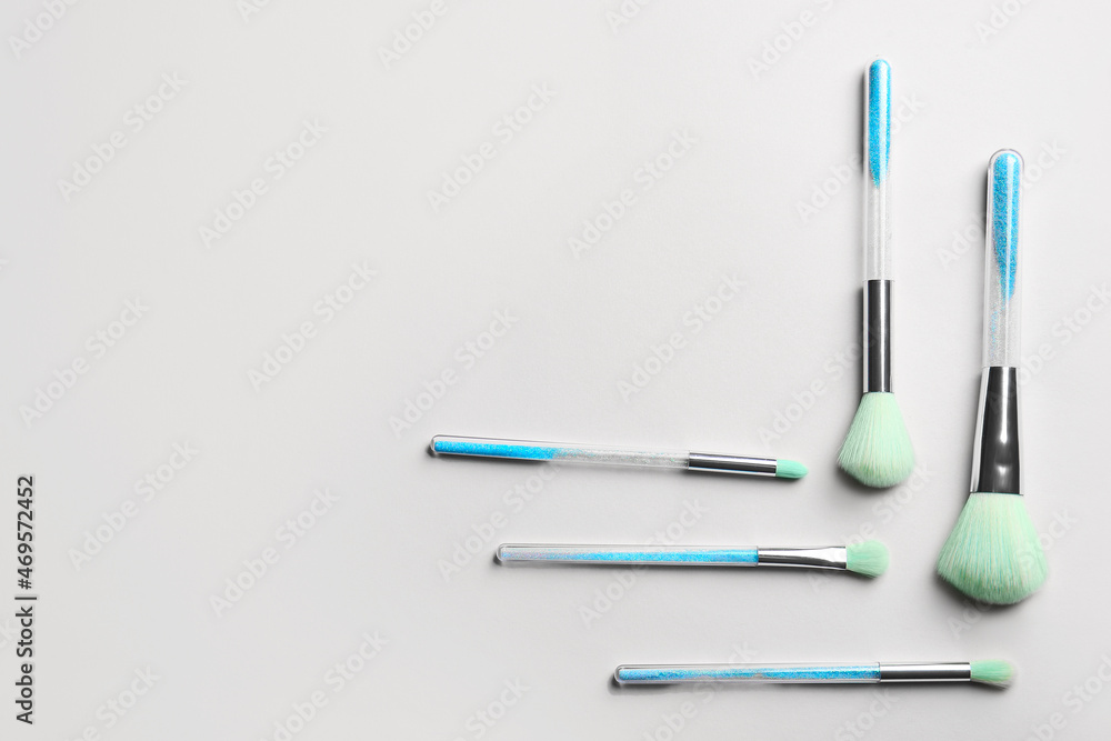 Different makeup brushes on light background Different makeup brushes on light background