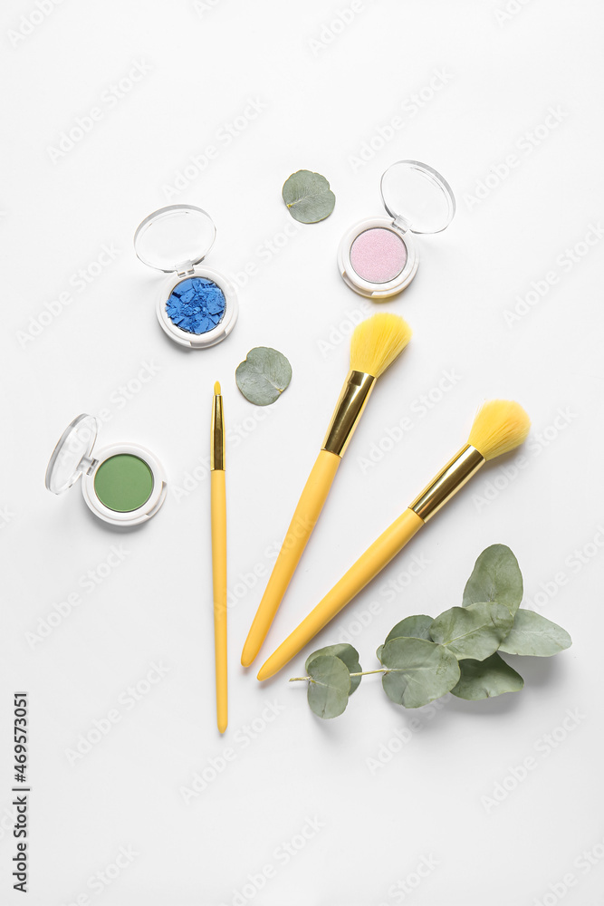 Set of decorative cosmetics with makeup brushes on white background Set of decorative cosmetics with makeup brushes on white background