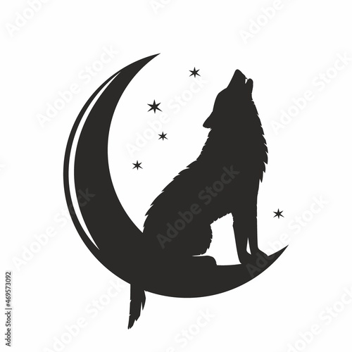 The silhouette of a wolf on a crescent moon sits and howls 