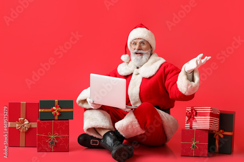 Santa Claus with laptop and...