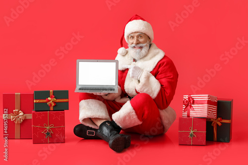 Santa Claus with laptop and...