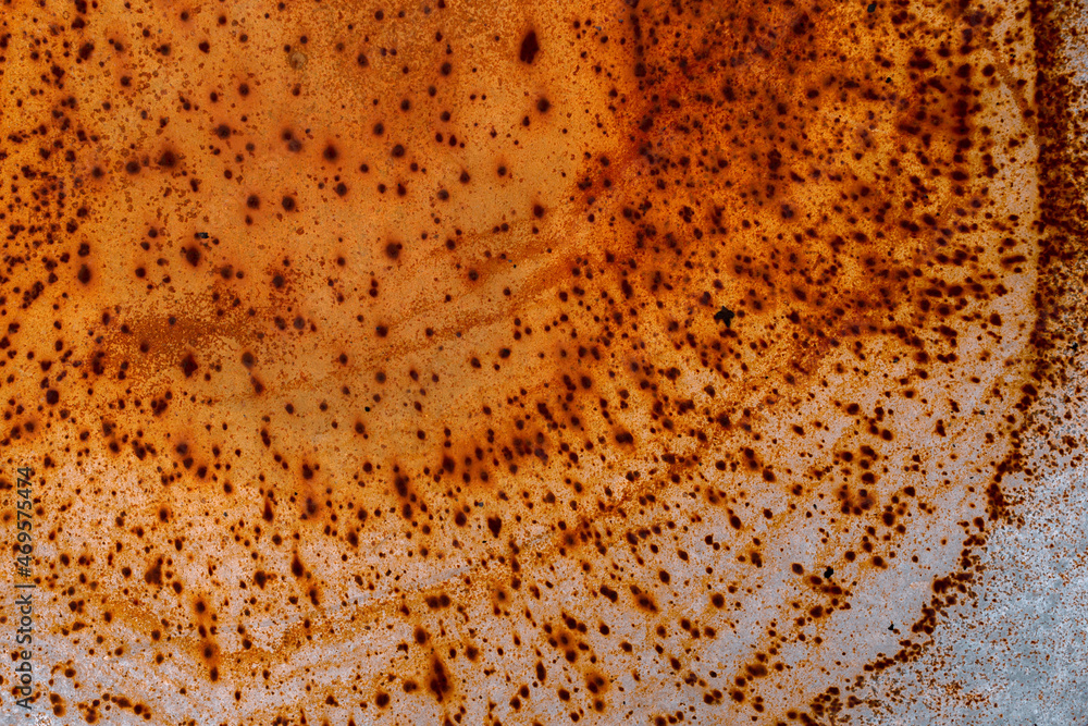 Rusty orange spots on the gray surface. Top view