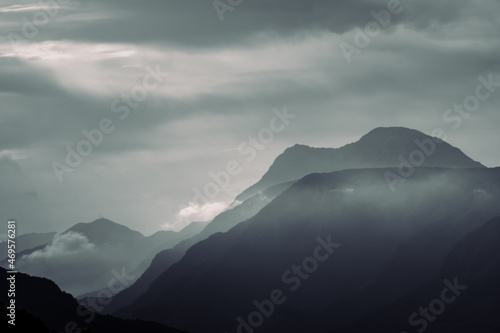 Mountain silhouettes. Foggy monochrome layered mountain silhouettes with clouds