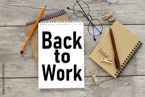 BACK TO WORK. notebook on wood background business concept #469577436