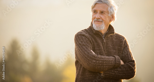 Happy senior man enjoying a lovele autumn day outdoors photo