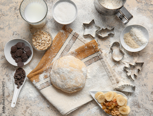 Fresh dough and ingredients for preparing homemade cookies on beige background