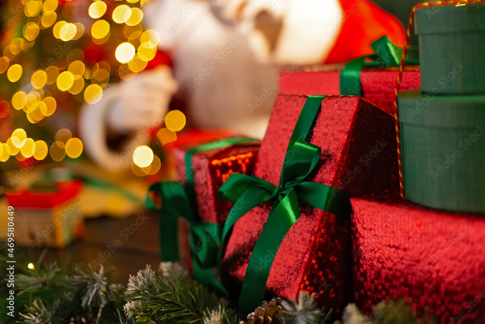 Santa Claus or Saint Nicholas prepares beautiful Christmas gift boxes which leves on desk. Holidays Santa Claus or Saint Nicholas prepares beautiful Christmas gift boxes which leves on desk. Holidays