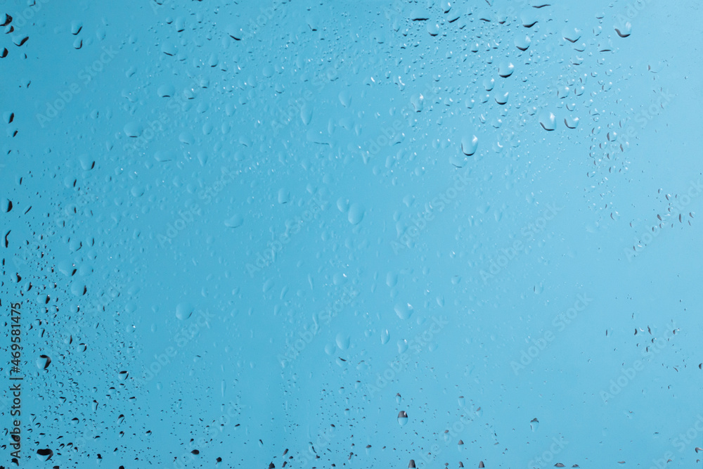 Blue backgrond with water drops. Wet glass. Blue backgrond with water drops. Wet glass.