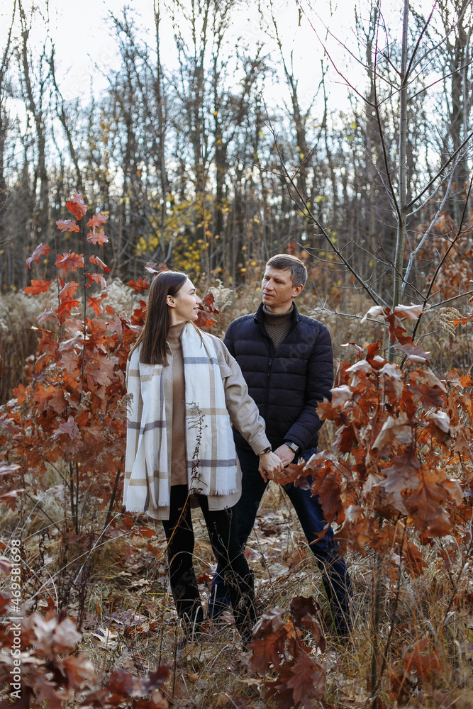 Fototapeta premium couple in love in the park on the background of autumn trees