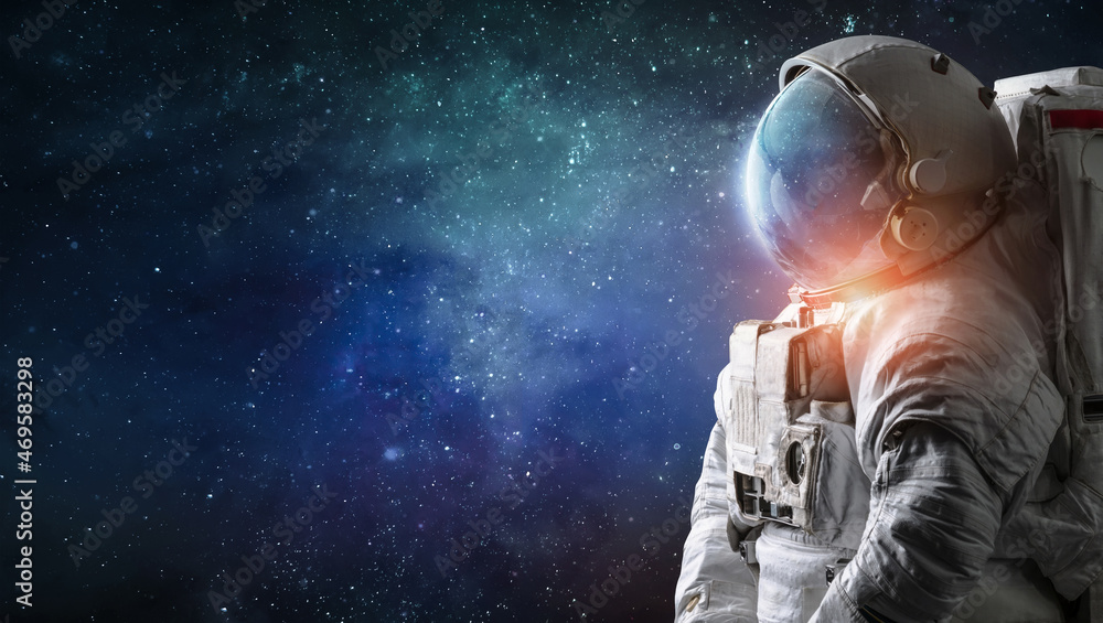 Astronaut in outer space. Spaceman with starry and galactic background. Sci-fi wallpaper. Elements of this image furnished by NASA - obrazy, fototapety, plakaty 