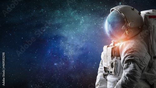 Astronaut in outer space. Spaceman with starry and galactic background. Sci-fi wallpaper. Elements of this image furnished by NASA photo