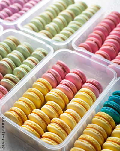 Sets of colorful macarons in plastic boxes.Sweet macarons of different tastes arranged in rows