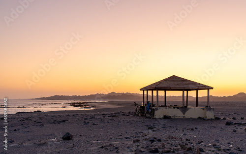 Serene Beachfront Gazebo at Sunset. A peaceful moment captured during sunset with a gazebo overlooking the tranquil beaches of southern Oman.