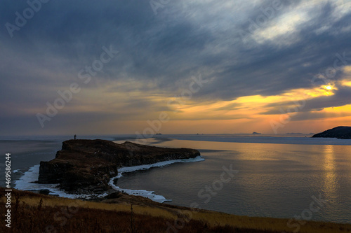 Picturesque rocky coast of the Russky Island in Vladivostok. Rocky coast of the Sea of Japan during a bright sunset.