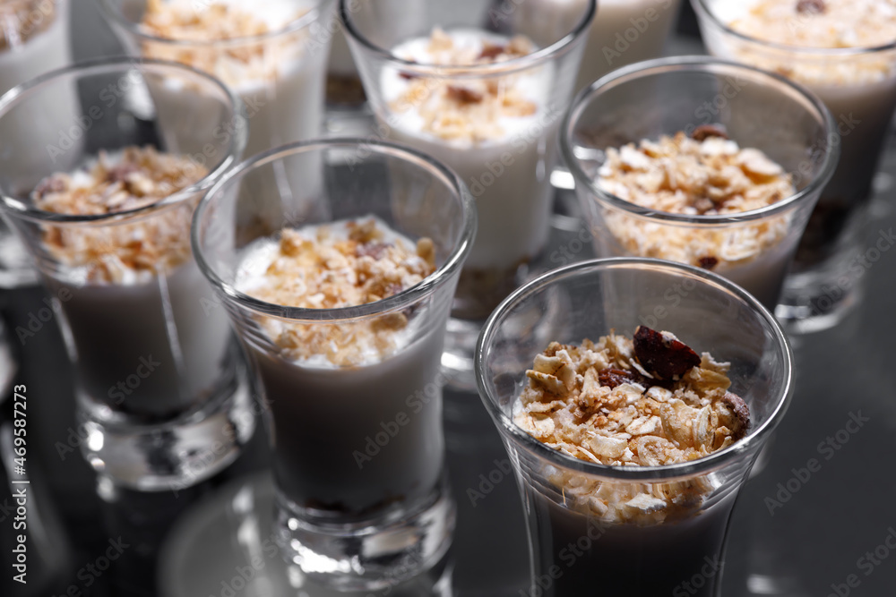 Creamy dessert of nuts in a glass stack on a dark background. Creamy dessert of nuts in a glass stack on a dark background.