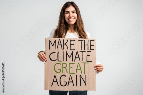 I love planet Earth. Caucasian cheerful woman holding carton placard with signs and looking at it. Concept of nature destruction and eco activism