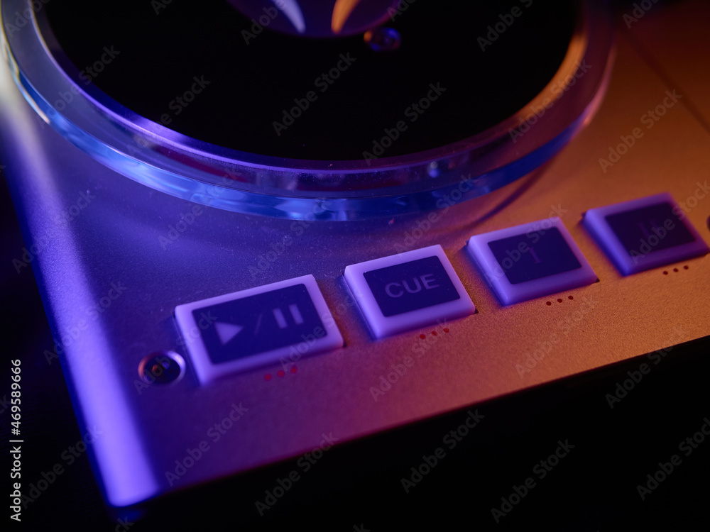 DJ midi controller at a nightclub party, lots of buttons and knobs