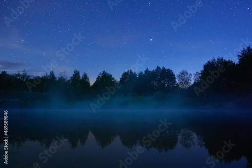 Fog on the river on a starry night in the forest. Dubna river, Moscow region, Russia. © Anna